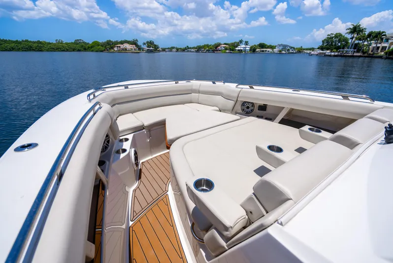  Yacht Photos Pics 2021 Boston Whaler 350 Realm boat with luxurious seating on a serene lake.