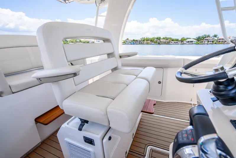  Yacht Photos Pics 2021 Boston Whaler 350 Realm interior with luxurious seating and steering wheel.