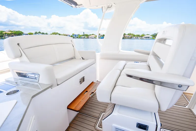  Yacht Photos Pics 2021 Boston Whaler 350 Realm interior with luxurious white seating and scenic water view.
