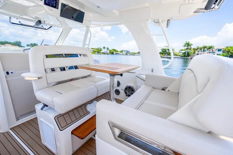  Yacht Photos Pics Luxurious interior of 2021 Boston Whaler 350 Realm boat with plush seating and wooden table.