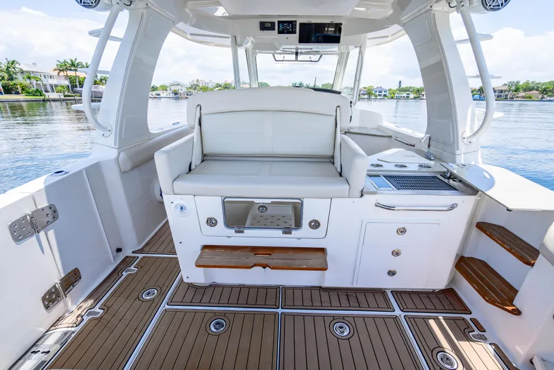  Yacht Photos Pics 2021 Boston Whaler 350 Realm interior with seating and storage, featuring sleek design and water views.