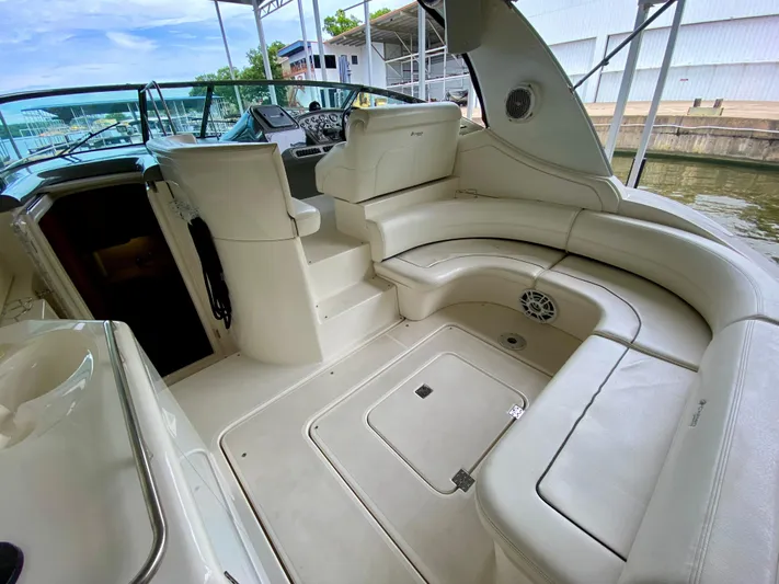  Yacht Photos Pics 2007 Cruisers Yachts 370 Express interior with white seating and helm, docked by the water.