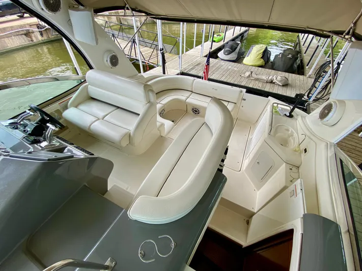  Yacht Photos Pics 2007 Cruisers Yachts 370 Express interior with white seating and helm, docked at marina.
