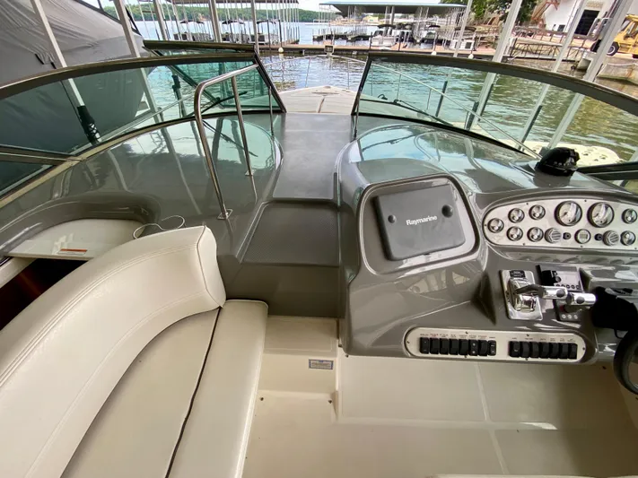  Yacht Photos Pics 2007 Cruisers Yachts 370 Express helm with Raymarine navigation, docked by the water.