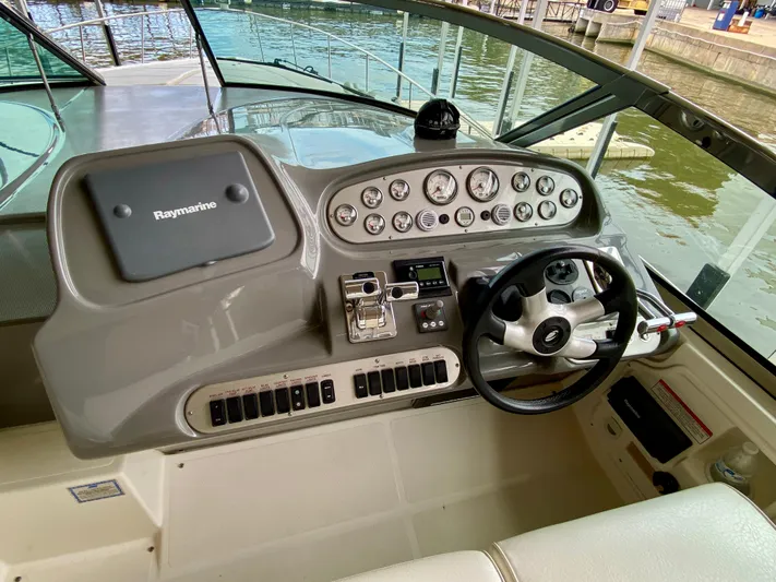  Yacht Photos Pics 2007 Cruisers Yachts 370 Express helm with Raymarine navigation system and steering wheel.