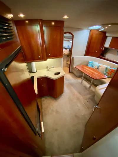  Yacht Photos Pics Interior of 2007 Cruisers Yachts 370 Express, featuring wood cabinetry and cozy seating area.
