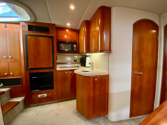  Yacht Photos Pics 2007 Cruisers Yachts 370 Express interior with wood cabinetry and modern kitchen amenities.