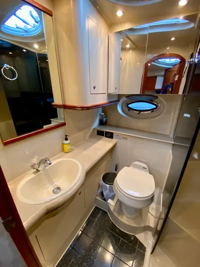  Yacht Photos Pics 2007 Cruisers Yachts 370 Express bathroom with sink, toilet, and porthole window.