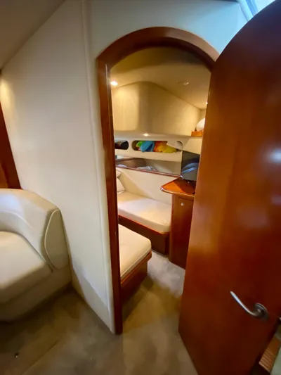  Yacht Photos Pics Interior cabin of 2007 Cruisers Yachts 370 Express, featuring cozy seating and wooden finishes.