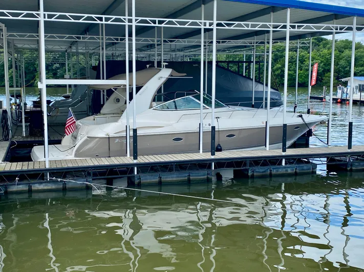  Yacht Photos Pics 2007 Cruisers Yachts 370 Express docked at a marina, surrounded by calm water.