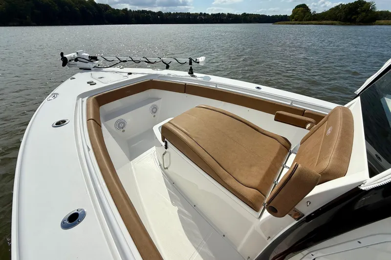  Yacht Photos Pics 2021 Sea Hunt Gamefish 27 Coffin Box boat interior with tan seating on a calm lake.