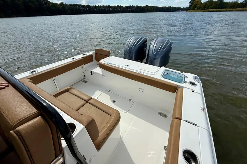  Yacht Photos Pics 2021 Sea Hunt Gamefish 27 Coffin Box boat interior with twin engines on a calm lake.