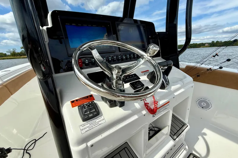  Yacht Photos Pics 2021 Sea Hunt Gamefish 27 Coffin Box helm with steering wheel and navigation screens.