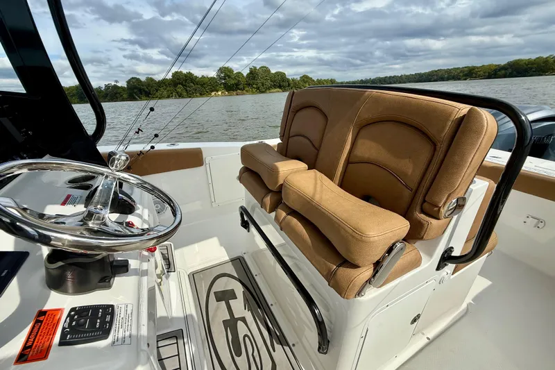  Yacht Photos Pics 2021 Sea Hunt Gamefish 27 Coffin Box boat interior with tan seating and steering wheel.