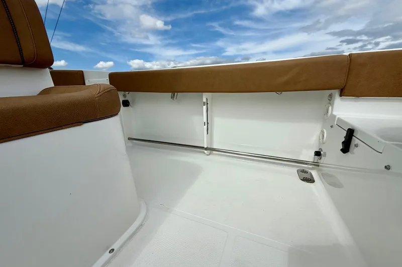 Yacht Photos Pics 2021 Sea Hunt Gamefish 27 Coffin Box interior with brown seating under blue sky.