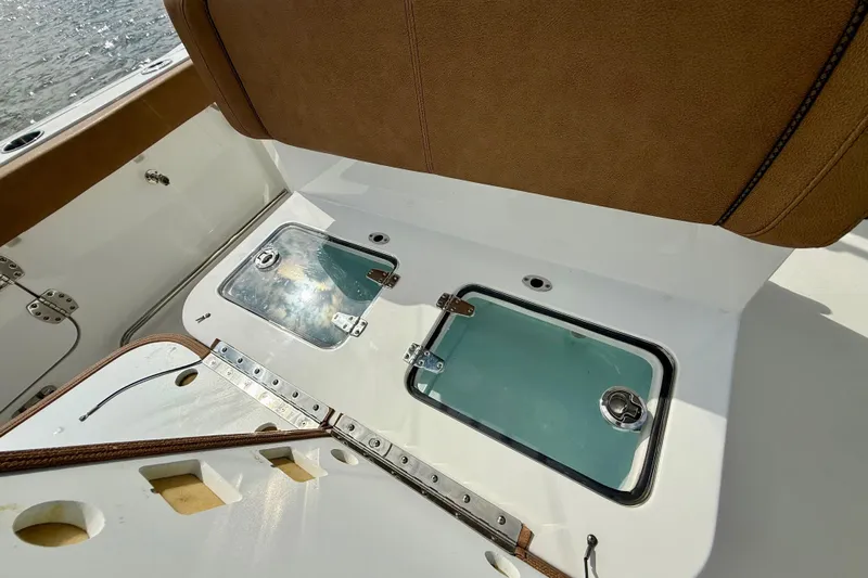  Yacht Photos Pics 2021 Sea Hunt Gamefish 27 Coffin Box interior with brown seating and storage compartments.