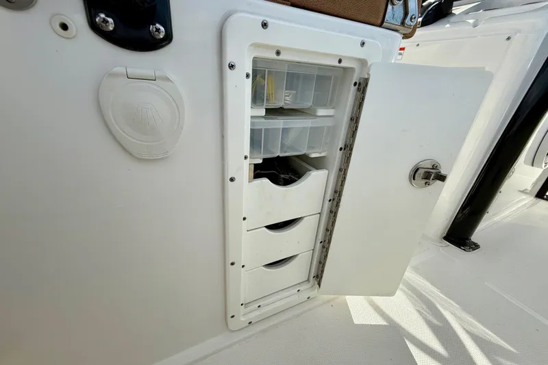  Yacht Photos Pics 2021 Sea Hunt Gamefish 27 Coffin Box storage compartment with open door and organized trays.