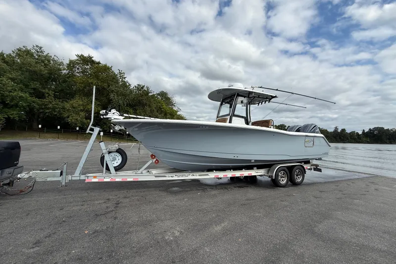  Yacht Photos Pics 2021 Sea Hunt Gamefish 27 Coffin Box boat on trailer by the water.