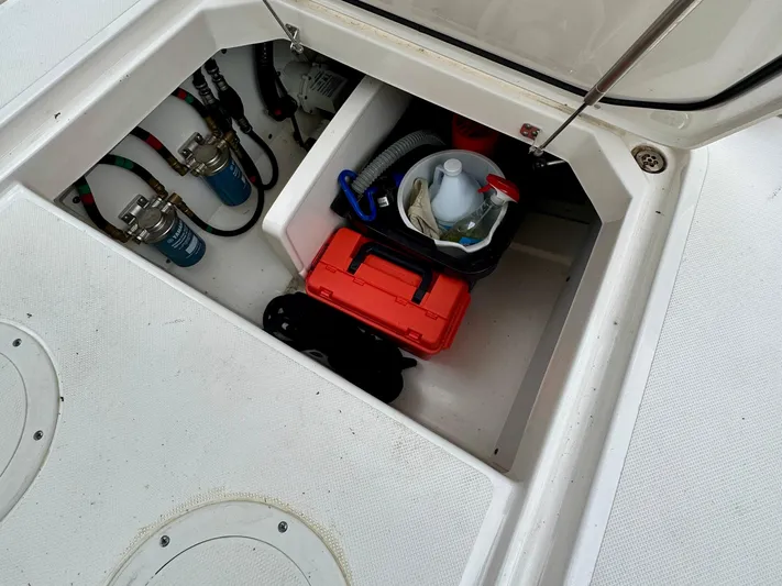  Yacht Photos Pics Storage compartment of 2024 Pursuit DC 295 Dual Console boat with equipment and supplies.