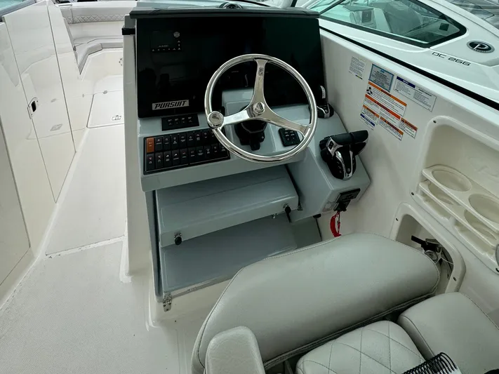  Yacht Photos Pics 2024 Pursuit DC 295 Dual Console boat helm with steering wheel and controls.