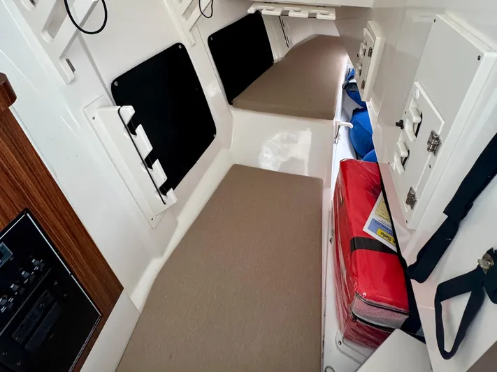  Yacht Photos Pics 2024 Pursuit DC 295 Dual Console cabin interior with seating and storage compartments.