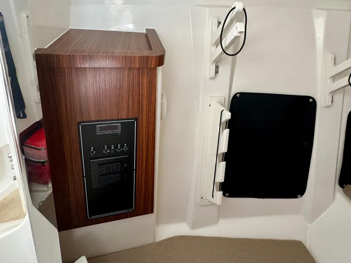  Yacht Photos Pics 2024 Pursuit DC 295 Dual Console interior with wood paneling and control panel.