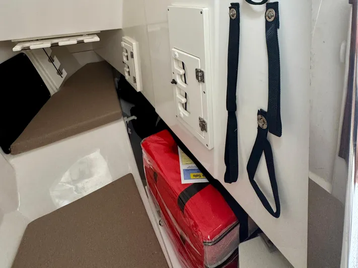  Yacht Photos Pics 2024 Pursuit DC 295 Dual Console interior with storage and safety equipment.