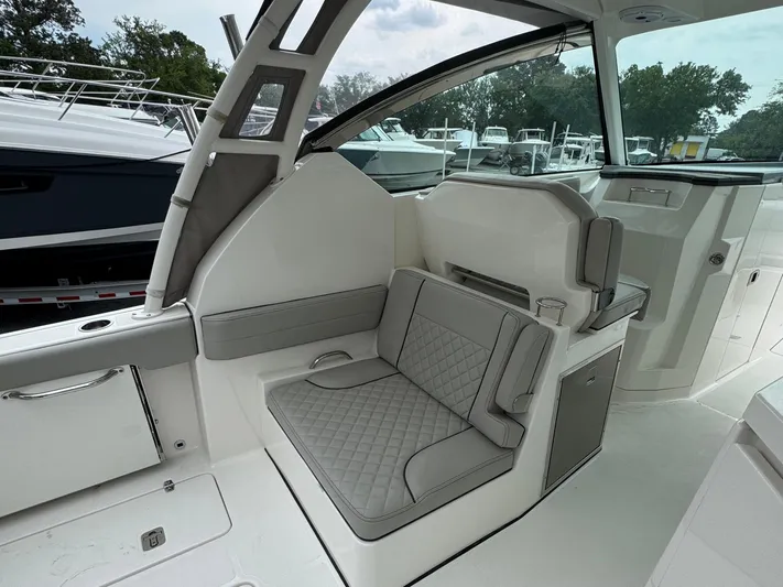  Yacht Photos Pics 2024 Pursuit DC 295 Dual Console interior with cushioned seating and modern design.