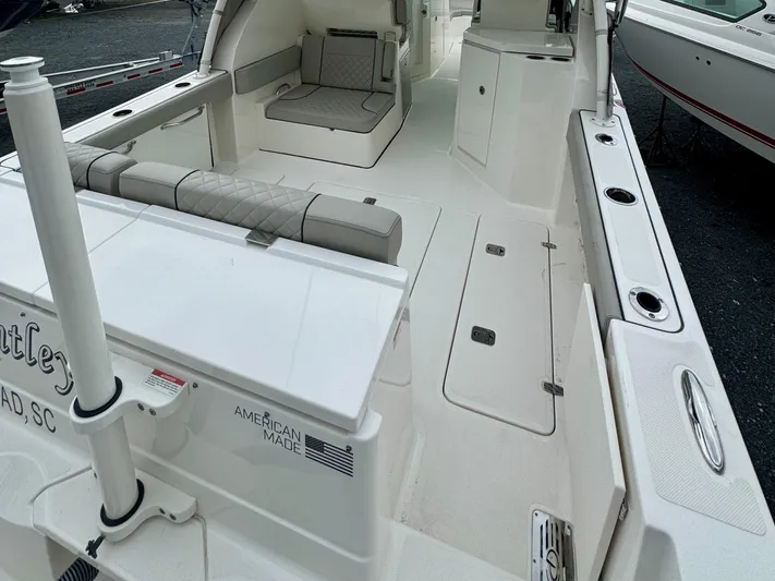  Yacht Photos Pics 2024 Pursuit DC 295 Dual Console boat interior with seating and storage compartments.