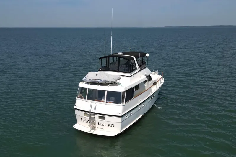 Lady Malan Yacht Photos Pics 1987 Hatteras 54 Motor Yacht cruising on open water under clear skies.