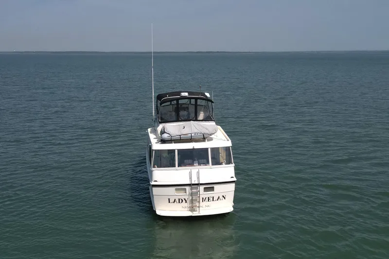 Lady Malan Yacht Photos Pics 1987 Hatteras 54 Motor Yacht on calm ocean waters, front view.