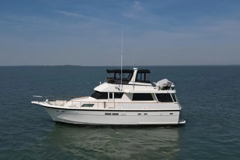 Lady Malan Yacht Photos Pics 1987 Hatteras 54 Motor Yacht on calm sea under clear sky.