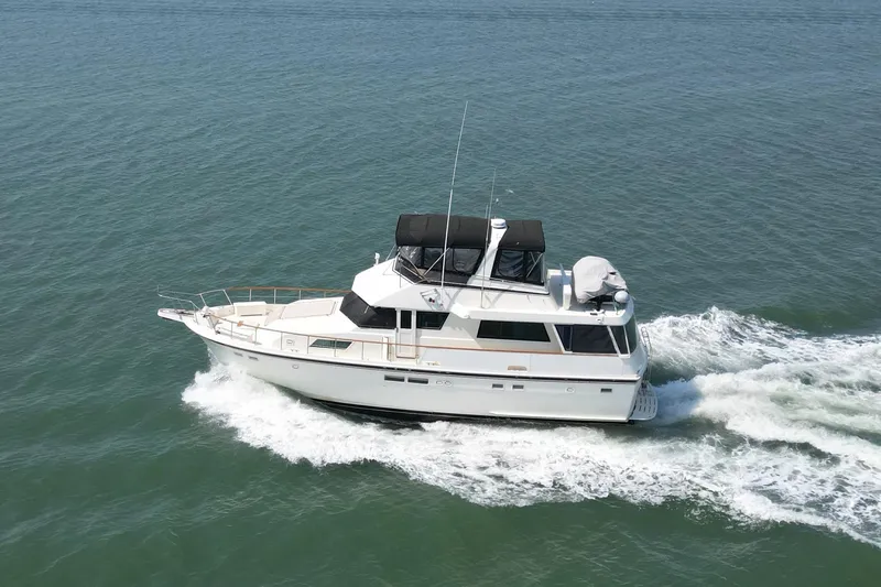 Lady Malan Yacht Photos Pics 1987 Hatteras 54 Motor Yacht cruising on open water, side view.
