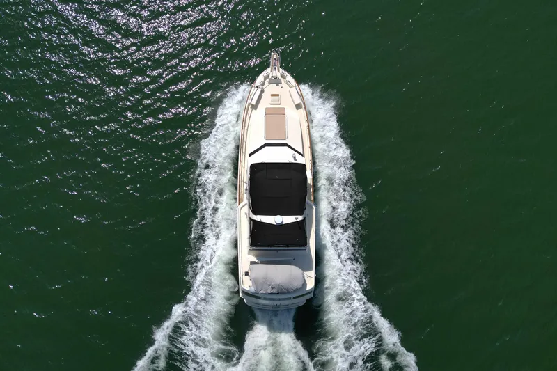 Lady Malan Yacht Photos Pics Aerial view of 1987 Hatteras 54 Motor Yacht cruising on open water.