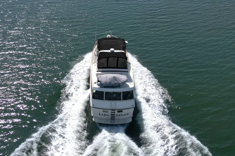 Lady Malan Yacht Photos Pics 1987 Hatteras 54 Motor Yacht cruising on open water, aerial view.