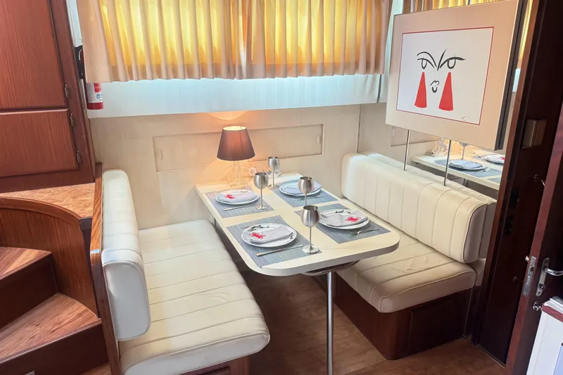 Lady Malan Yacht Photos Pics Interior of 1987 Hatteras 54 Motor Yacht with elegant dining area and modern art.