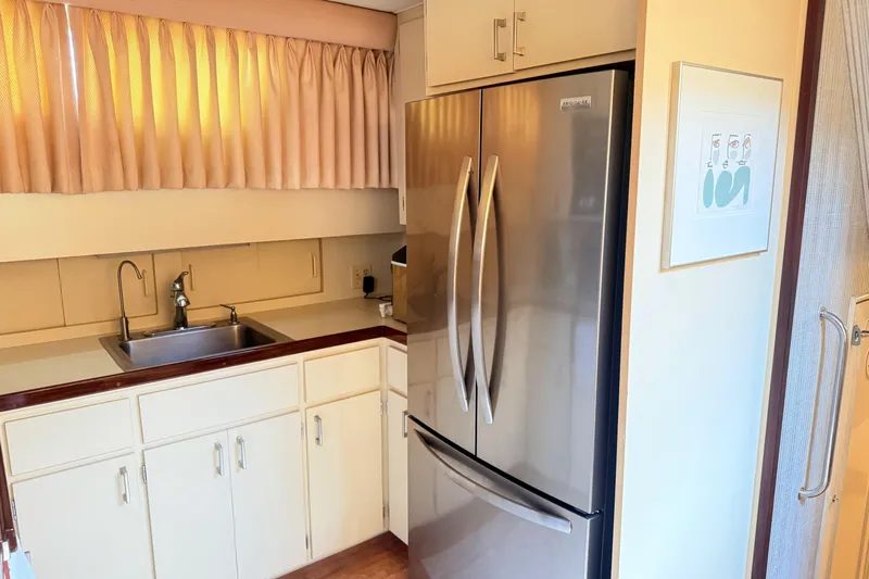 Lady Malan Yacht Photos Pics 1987 Hatteras 54 Motor Yacht kitchen with stainless steel fridge and sink.