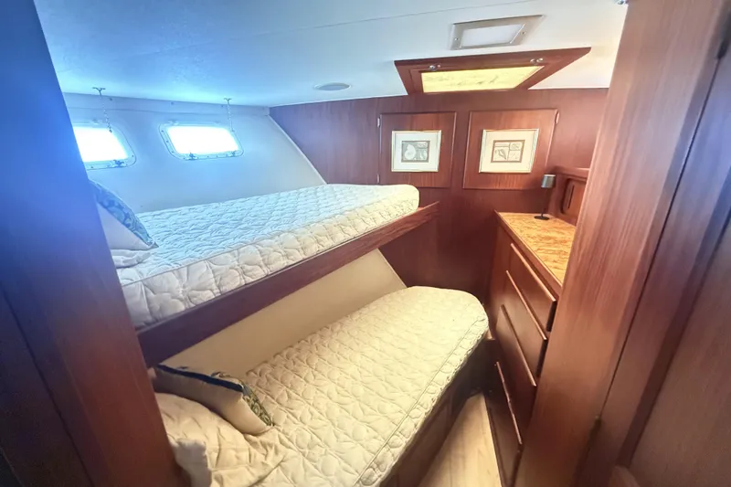 Lady Malan Yacht Photos Pics 1987 Hatteras 54 Motor Yacht cabin with bunk beds and wooden interior.