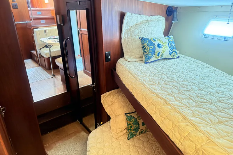 Lady Malan Yacht Photos Pics Interior of 1987 Hatteras 54 Motor Yacht with cozy twin beds and dining area.