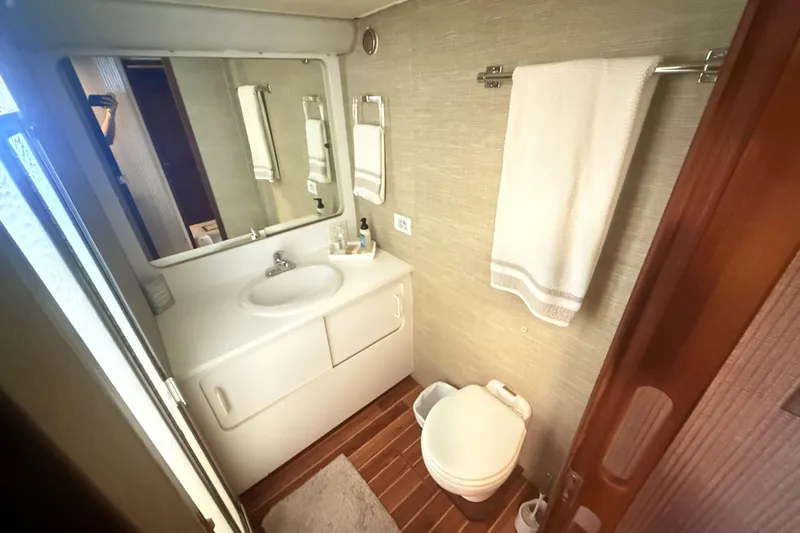 Lady Malan Yacht Photos Pics Bathroom interior of 1987 Hatteras 54 Motor Yacht with sink, mirror, and towel rack.