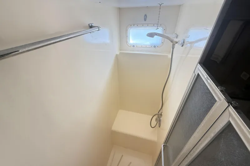 Lady Malan Yacht Photos Pics Shower area in 1987 Hatteras 54 Motor Yacht with window and handheld showerhead.