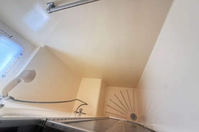 Lady Malan Yacht Photos Pics Shower area in 1987 Hatteras 54 Motor Yacht with handheld showerhead and window.