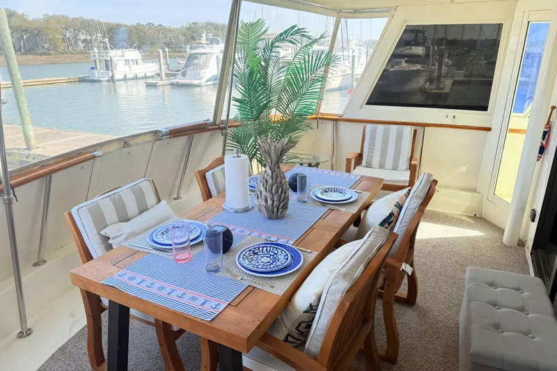 Lady Malan Yacht Photos Pics Elegant dining area on 1987 Hatteras 54 Motor Yacht with marina view.