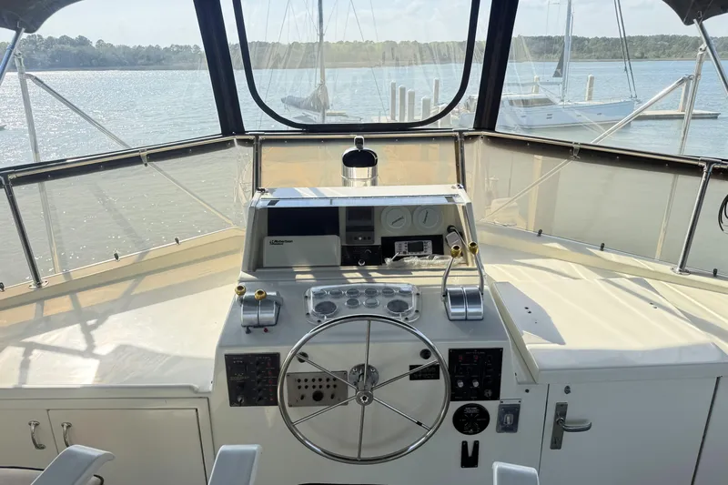 Lady Malan Yacht Photos Pics Helm of 1987 Hatteras 54 Motor Yacht with steering wheel and control panel.