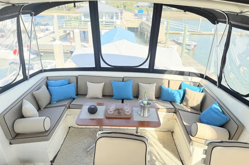 Lady Malan Yacht Photos Pics 1987 Hatteras 54 Motor Yacht interior with cozy seating and blue cushions.