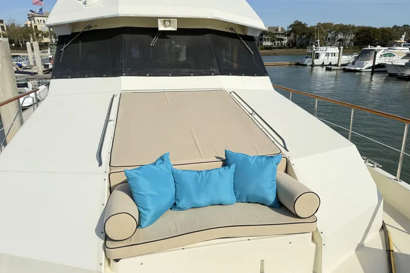Lady Malan Yacht Photos Pics 1987 Hatteras 54 Motor Yacht with cushioned deck seating and blue pillows at marina.