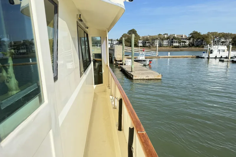 Lady Malan Yacht Photos Pics 1987 Hatteras 54 Motor Yacht docked at a marina, calm waters, clear sky.