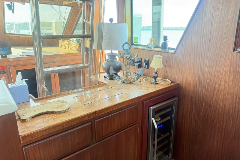 Lady Malan Yacht Photos Pics Interior of 1987 Hatteras 54 Motor Yacht with wooden cabinetry and decorative lamps.