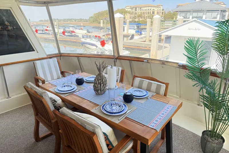 Lady Malan Yacht Photos Pics Elegant dining area on 1987 Hatteras 54 Motor Yacht with marina view.