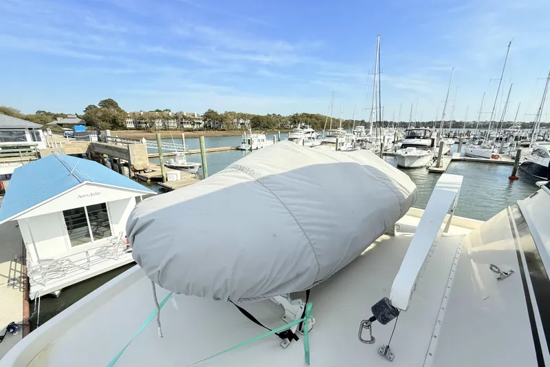Lady Malan Yacht Photos Pics 1987 Hatteras 54 Motor Yacht docked at marina with covered equipment on deck.